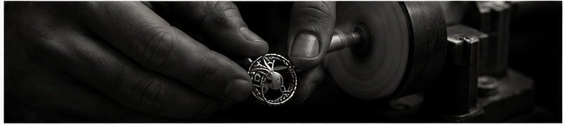 Artisan finishing a silver jewellery piece at the polishing wheel
